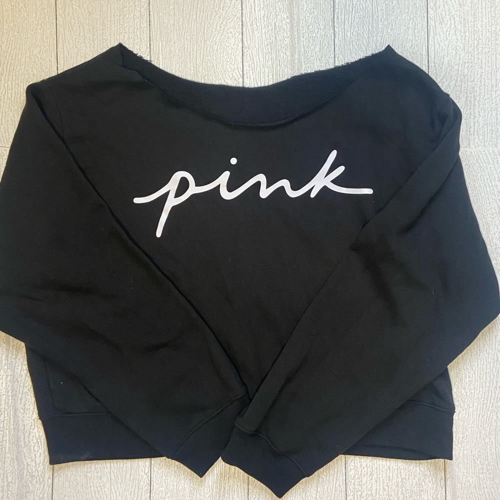 Pink Victoria’s Secret off should sweatshirt.